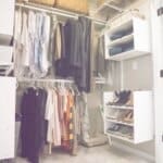 Neatly organized closet with hanging clothes, woven baskets on top shelves, and shoe racks with various footwear.